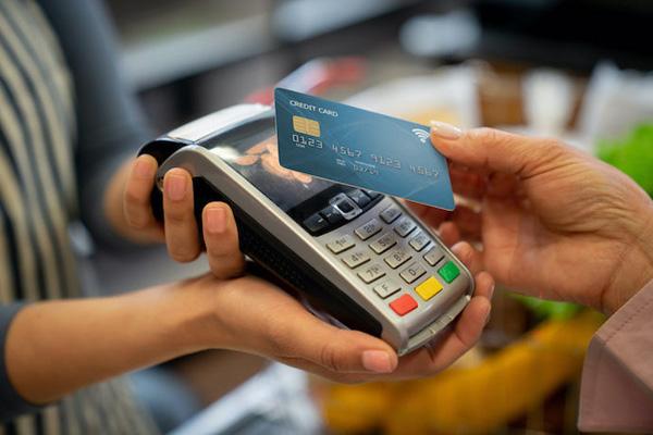 Credit card being used for a secure payment at a digital payment terminal.